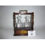 A mahogany Tantalus with two whisky bottles est: £25-£45 (AB12)