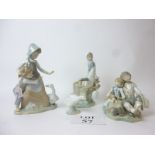 Four Lladro figurines to include boy,