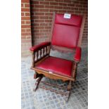 A c1900 rocking chair upholstered in red and in very good condition (has an anti rocking stop to