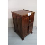 An early 20c mahogany small cupboard with two pairs of small panelled doors est: £40-£60