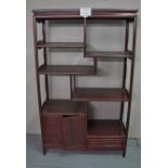 A 20c Chinese rosewood open display cabinet with a small cupboard and secret drawer est: £100-£200