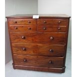 A Victorian walnut chest of four small drawers over three long drawers with turned handles (needs