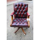 A 1980's Burgundy leather swivel desk chair est: £40-£70