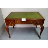 A 1920's walnut writing desk with a green tooled leather over three drawers and cabriole legs est: