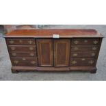 A late 20c mahogany sideboard with drawers either side of a centre cupboard est: £80-£140