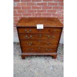 A George III mahogany small gentleman's chest of four long graduated drawers with ornate brass