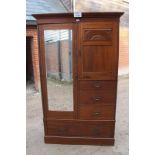 An Edwardian walnut wardrobe compactum with hanging space,