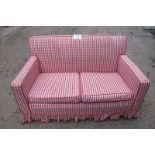 A two seater sofa upholstered in a red check material est: £50-£80