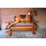 A fine figured rocking horse complete with saddle and harness in good condition (4 ft tall and 37