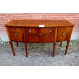 A George III mahogany bow fronted sideboard with centre drawer flanked either side by cupboard est: