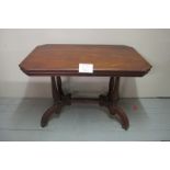 A 19c mahogany decorative table with reeded legs centre stretcher and splayed feet with casters