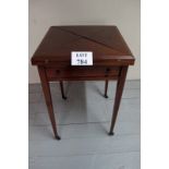 An Edwardian mahogany inlaid envelope card table with a centre brown leatherette panel and single