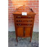 An Edwardian mahogany inlaid music cabinet with drawers over cupboards est: £50-£80