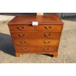 A George III mahogany chest of two short over three long drawers with brass swan handles and