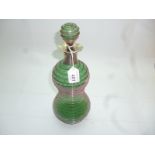 A decorative waisted green glass decante