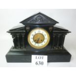 A Victorian black slate mantle clock of