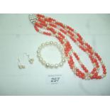 A fresh water pearl and coral coloured b