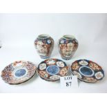 A pair of Imari palate ribbed vases and