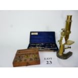 An antique brass microscope;