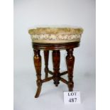 An upholstered piano stool with adjustable rotating seat est: £30-£50 (F2)