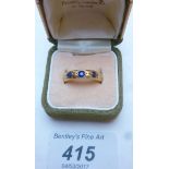 An 18ct gold three sapphire set band ring (size N) boxed est: £70-£100