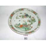 A Chinese deep salver or dish painted with insects amongst a flowering tree in a garden in Famille