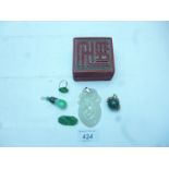 Five items of jade jewellery to include two pendants,