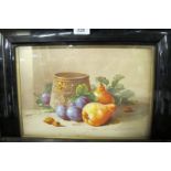 A framed and glazed still life watercolour study of fruit by a bowl signed indistinctly lower right