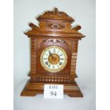 An American oak cased mantle clock by the Ansonia Clock Company (key and pendulum with auctioneer)