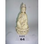 A Chinese model of a Guanyin holding a pearl and seated on a lotus flower,