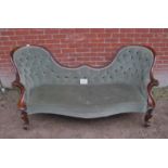 A Victorian mahogany framed sofa upholstered in deep buttoned green velvet est: £300-£500