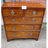 A George III mahogany chest of two short over three long drawers with brass oval handles and