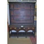 An 18c oak dresser with later boarded plate rack over drawers est: £250-£400