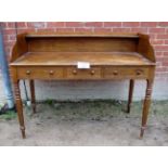 A George III desk with raised back over three short drawers and turned legs est: £200-£300