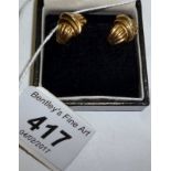 A pair of 9ct gold earrings inset with a