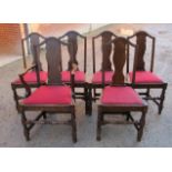 A set of six oak dining chairs with red