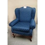 An early 20c blue upholstered winged arm