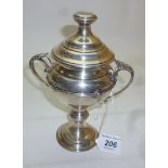 A two handled lidded silver trophy with