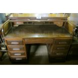 A c1900 oak D shape roll top desk with f