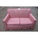 A two seater sofa upholstered in a red c