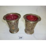 A pair of silver open work vases with cr