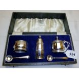 A boxed silver condiment set comprising