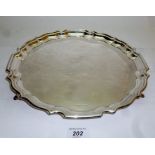 A large silver salver with pie crust edg