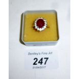 A silver ring inset with centre ruby and fourteen spinels (size O) est: £100-£200