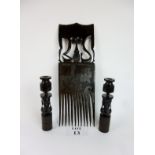 An African carved hardwood large/oversized comb and a pair of carved figural candlesticks est: