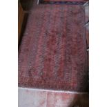 A Persian early 20c rug on Burgundy ground (174 x 104 cm approx) est: £30-£50