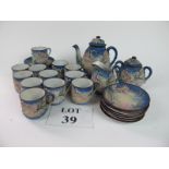 A highly decorative Japanese eggshell tea set for 12 with relief moulded dragon chasing flaming