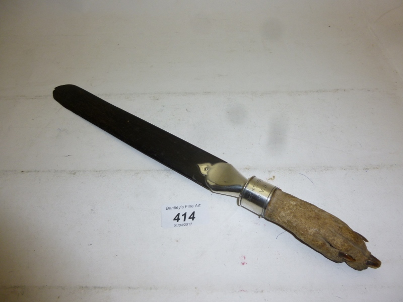 A ebony page turner with animal claw handle and silver mounts London 1929 est: £30-£50