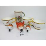 A Staffordshire fox's head stirrup cup and two others;