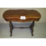 A fine Victorian figured walnut turn over card table with green baize over two carved end columns